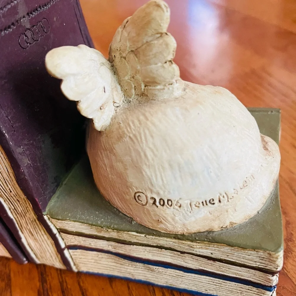 A pair of  stone bunny inc.2006 Telle M. Stein, Dog angel with ball bookends